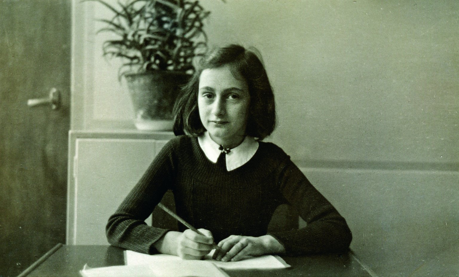 Anne Frank at her desk at the Montessori School in Amsterdam (winter 1940). In this picture, Anne is 11 years old and in sixth grade.
