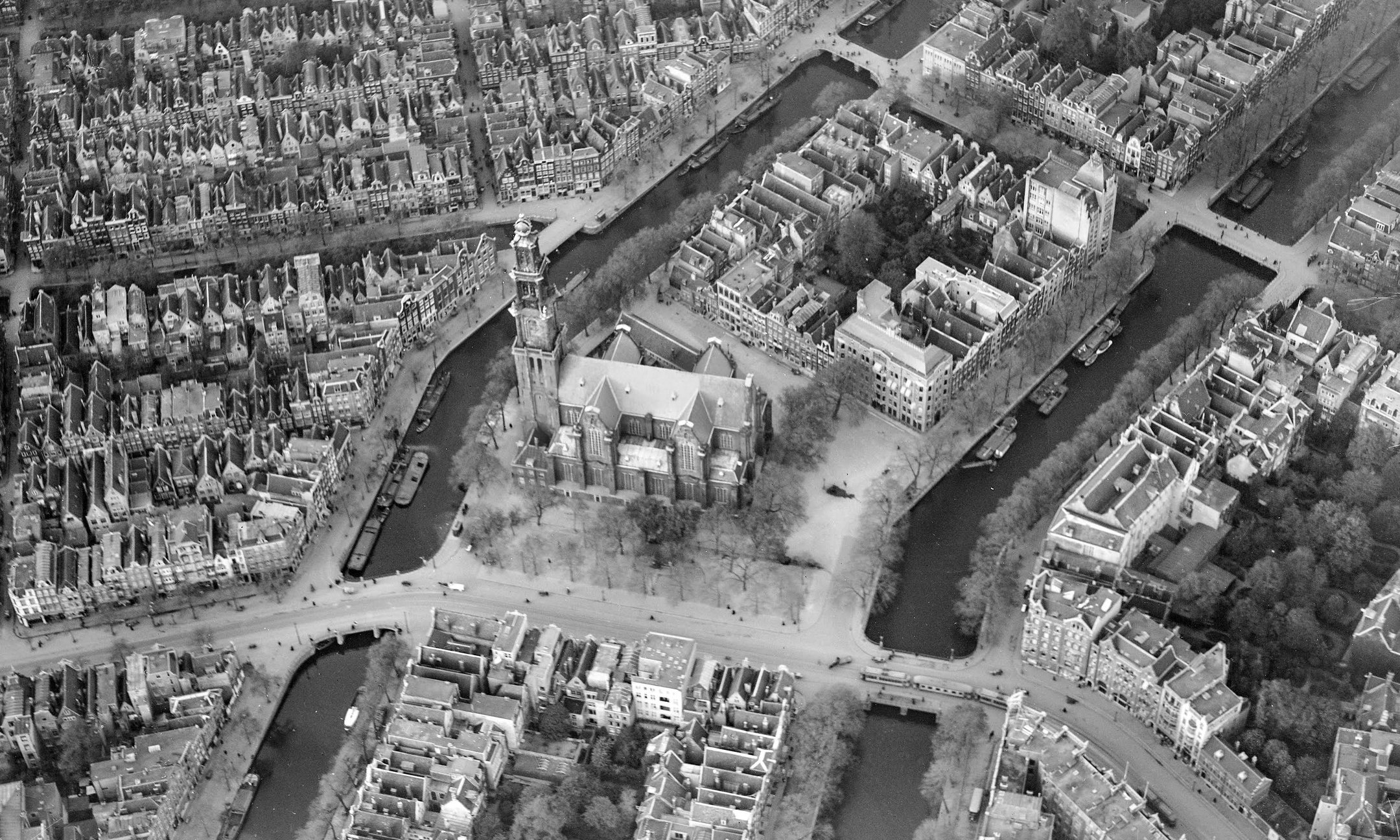 Aerial photo of Amsterdam. The tower of the Westerkerk is in the centre. Prinsengracht 263 is in the block above the tower, next to the canal.